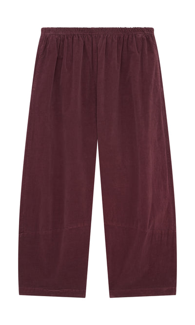 Plümo  Architect Pants - Lupins: Wide-leg maroon needlecord pants with elastic waist, sustainably made, shown flat on white.