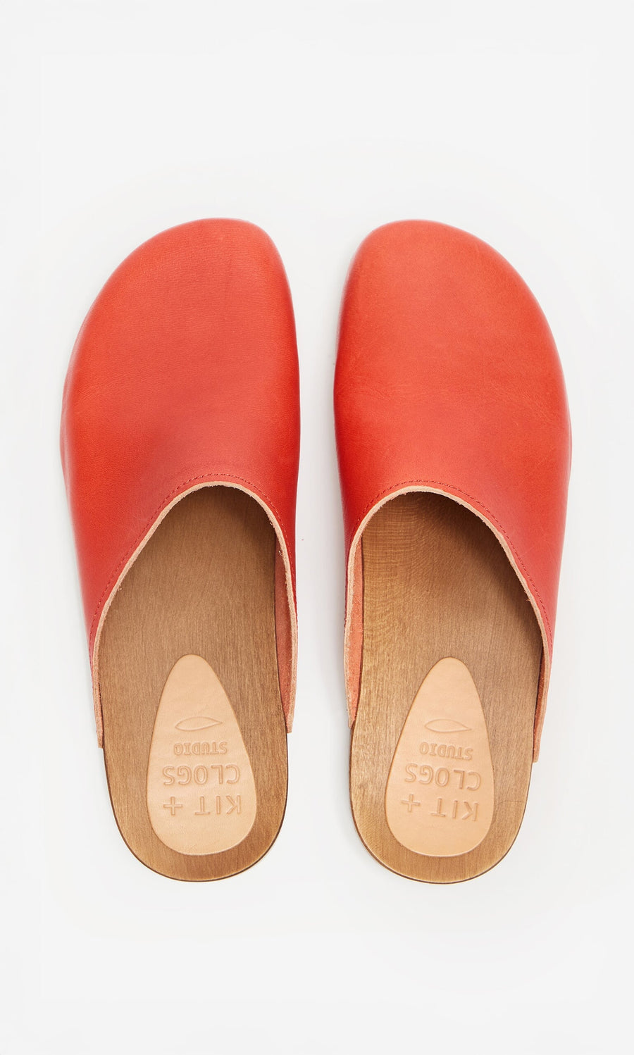 Plümo- A pair of Carlie Clogs - Photoshoot Sample, red with wooden soles, shown from above on a white background.