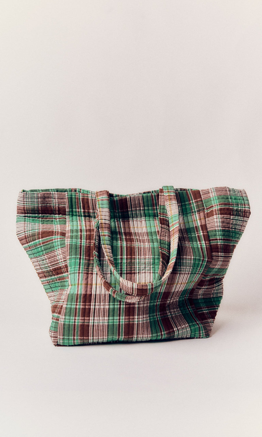 Plümo- The Checked Quilted Bag is a large cotton shoulder bag with green, white, and brown plaid stripes.