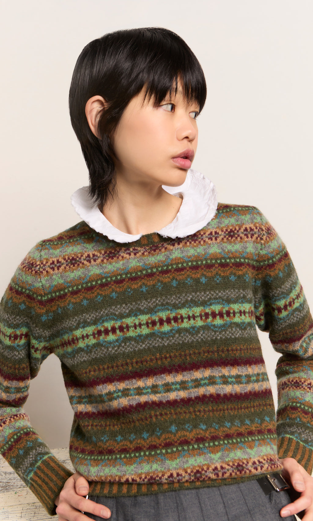 Plümo  Model wears the Iona Fairisle Jumper with a white collar, looking to the side against a plain background.