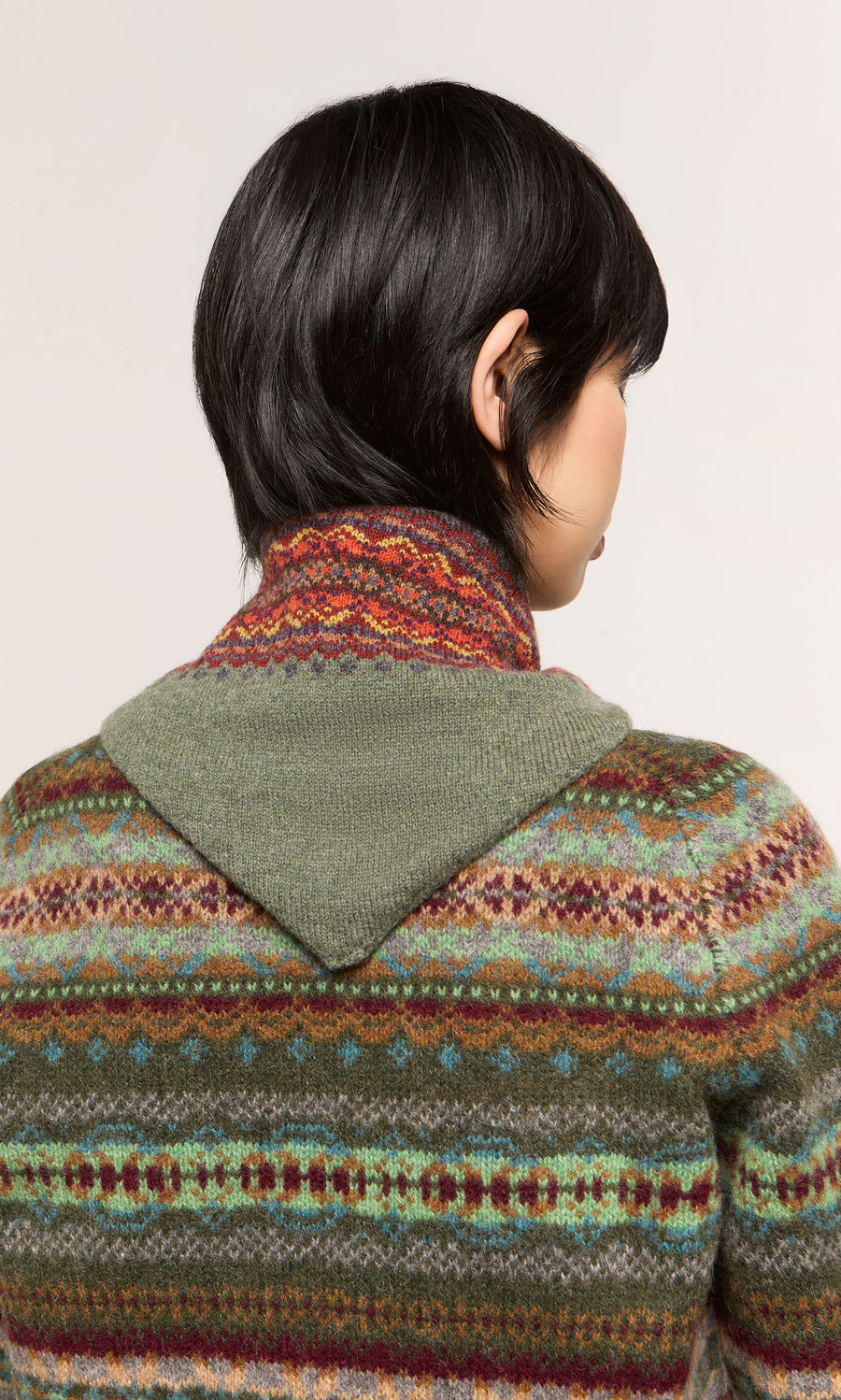Plümo  Person with short black hair in the Lenie Necktie, shown from behind; inspired by Scottish Borders style.
