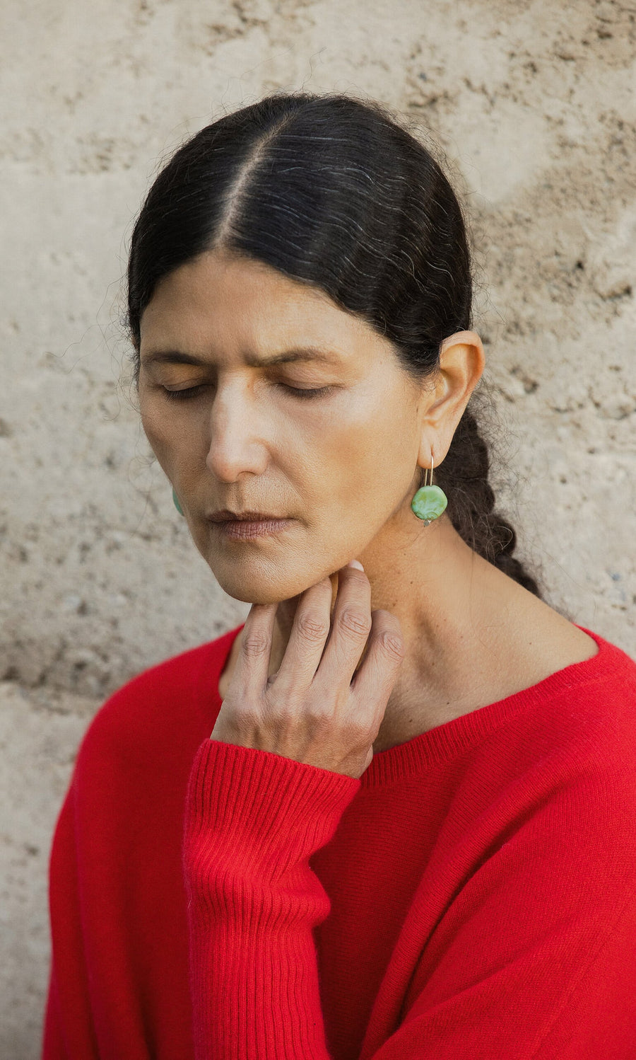 Plümo- A woman with dark hair in a braid wears Erika Earrings, eyes closed and hand on her neck.