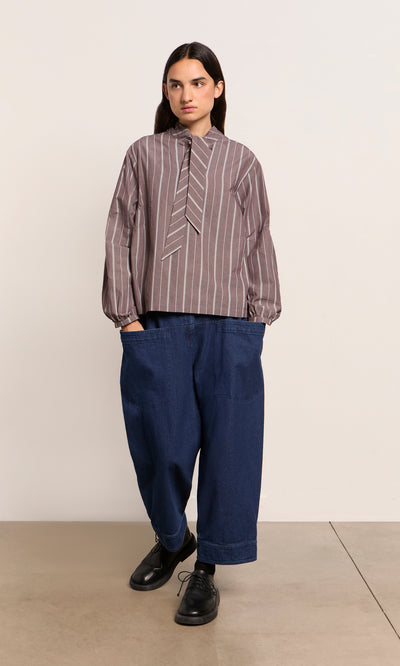 Plümo  Person in tie-detail top and Polder Pants - Original Denim stands against a plain background.