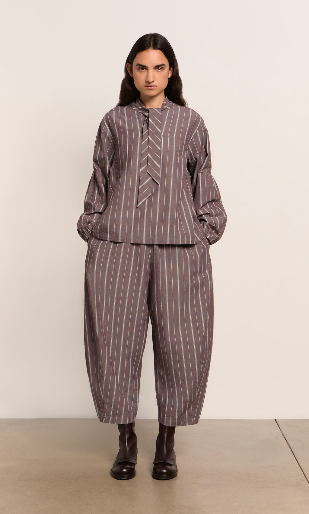 Plümo  Person in a loose Kleist Blouse - Liquorice with balloon sleeves and matching pants, styled by Plümo Studio.