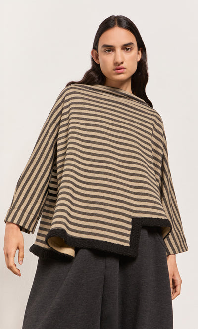 Plümo  A model wears the Bloch Funnel Top in taupe and black stripes with wide sleeves and an asymmetric cut-out hem.