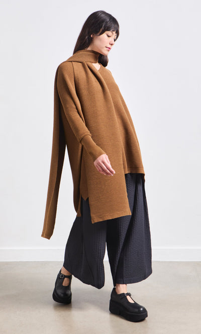 Plümo- Woman in a loose brown top, black wide-leg pants, and the Janie Scarf - Chestnut against a plain background.