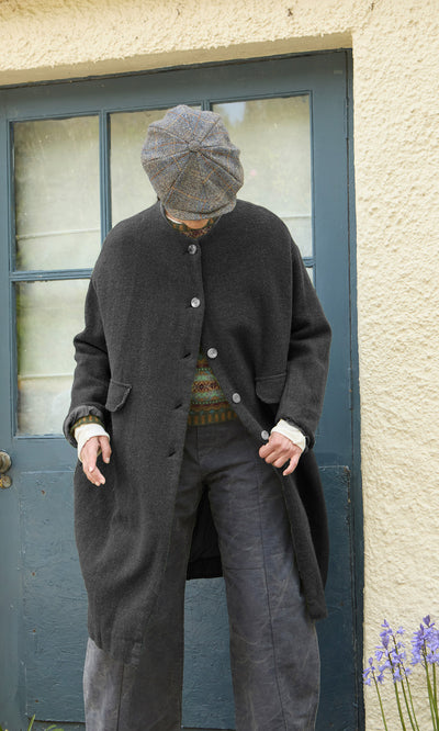 Plümo  A person wearing a charcoal grey Barra Harris Coat - Charcoal and a tweed flat cap.