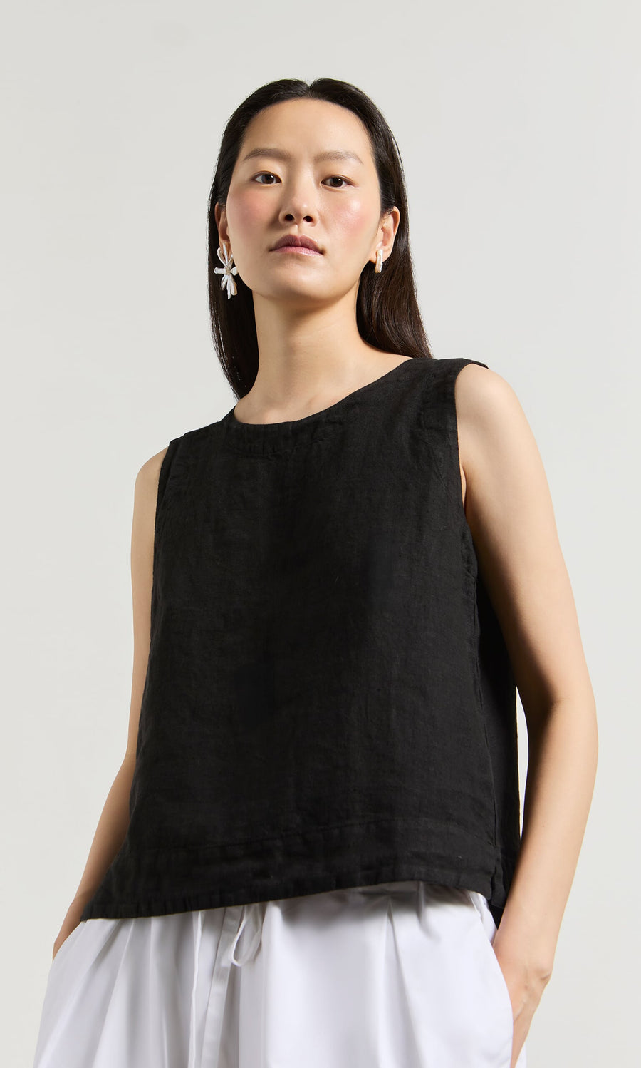 Plümo- Woman in the Linda Top - Solid Black and white pants—sustainably made with San Francisco-inspired style.