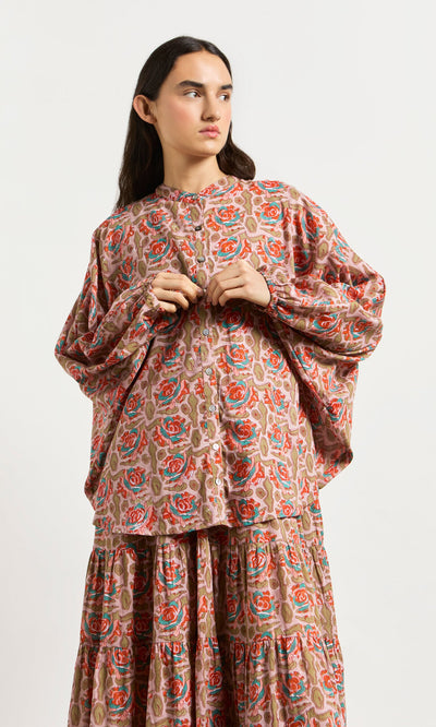 Plümo- Person wearing the Lotus Flower Blouse, an ethically made, block-printed cotton floral top, against a plain white background.