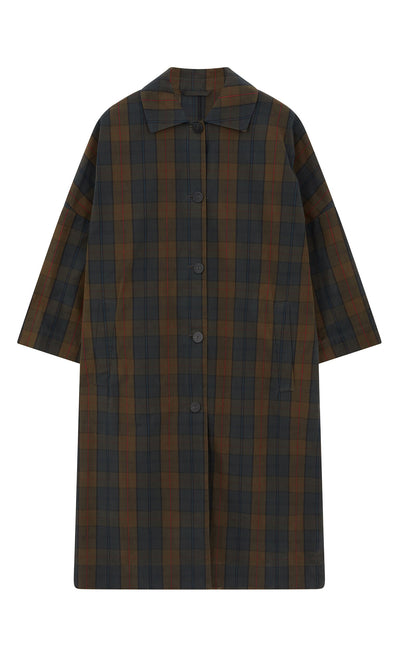 Plümo- The Doherty Coat - Tartan is a loose, plaid coat with a collar, button front, and wide sleeves in dark green and brown.
