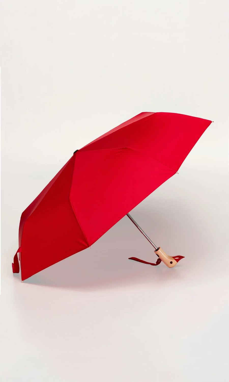 Plümo  The Duck Umbrella - Red, wind resistant with a wooden handle, is open on a plain white background.