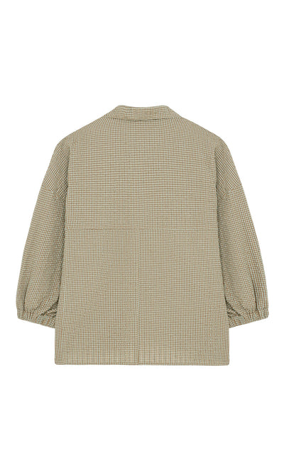 Plümo- Back view of the Fern Blouse—a boxy, relaxed-fit cotton seersucker shirt with beige and green checks and cuffed sleeves.