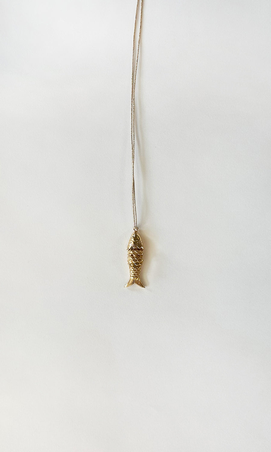 Plümo  Celine Necklace: Gold-plated fish pendant on an adjustable chain, ideal for layering; shown on a white background.