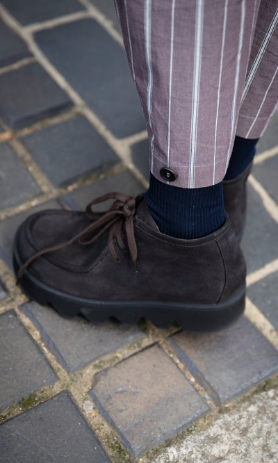 Plümo  Rolla Boots: handcrafted Italian lace-up boots with thick, wavy lug soles worn with striped trousers and navy socks.