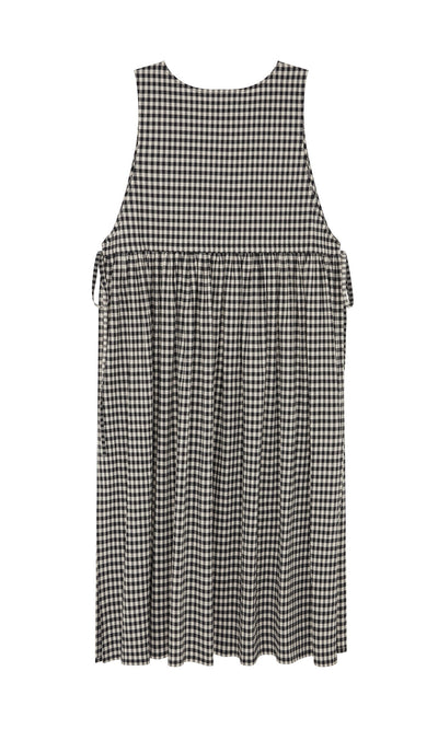 Plümo- The Apron Dress - Gingham features a black and white check, flared skirt, gathered waist, and roomy pockets.