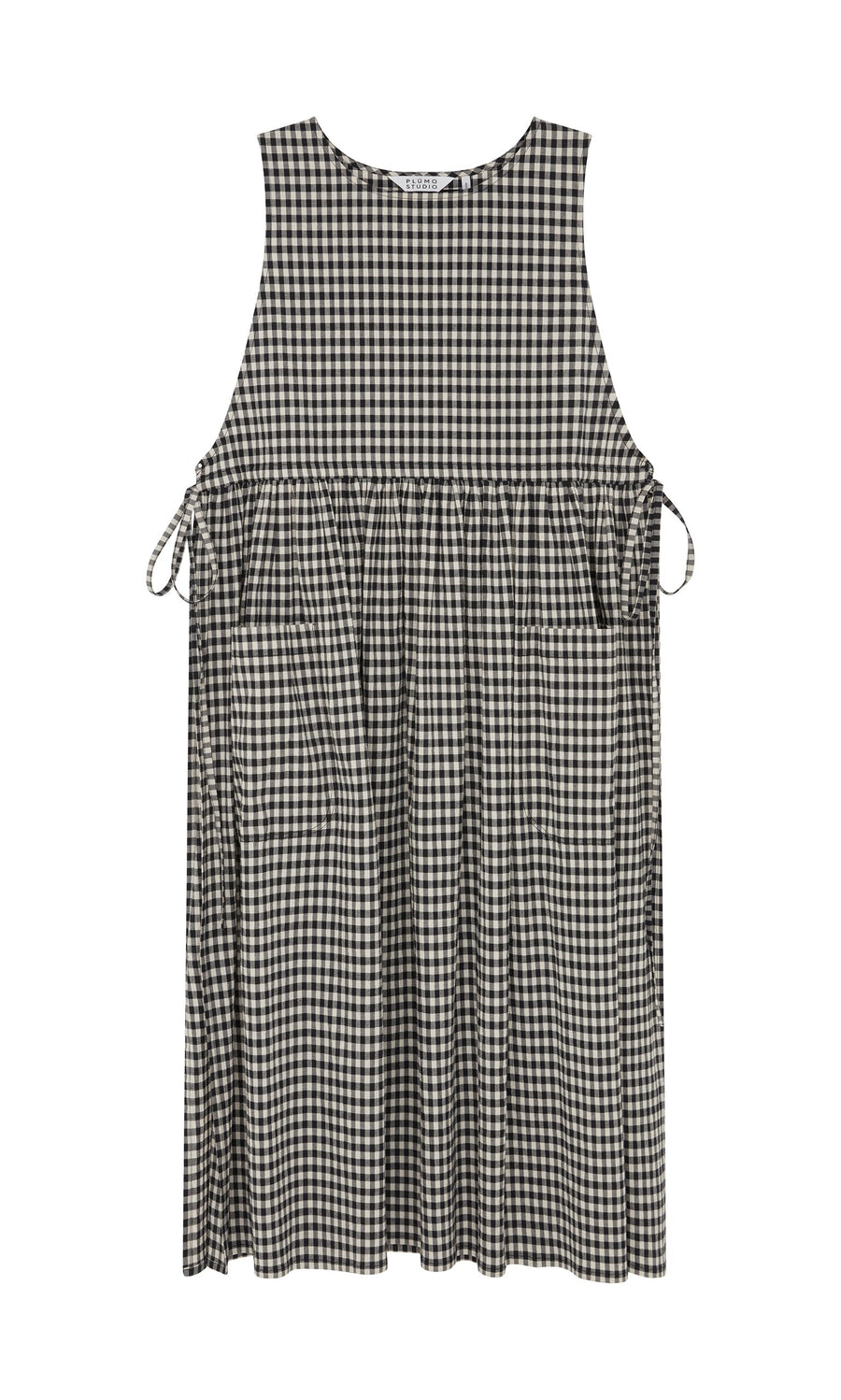Plümo- Apron Dress - Gingham: Sleeveless black-and-white check dress with side bows, pockets, and gathered waist.