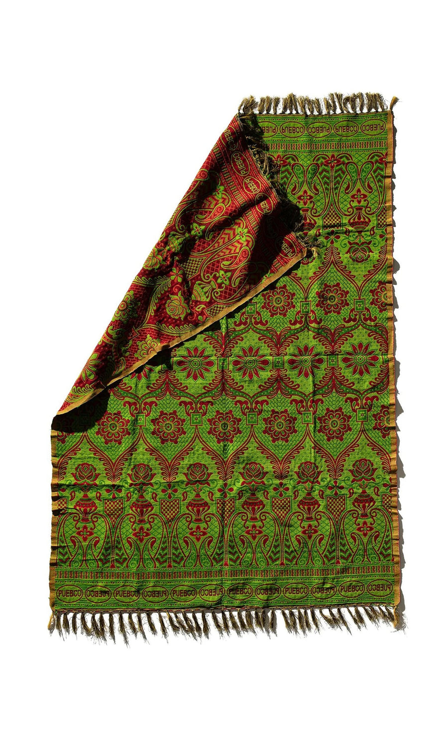 Plümo- Folded Green Jacquard Rug with fringed edges and intricate green, red, yellow patterns on a white background.