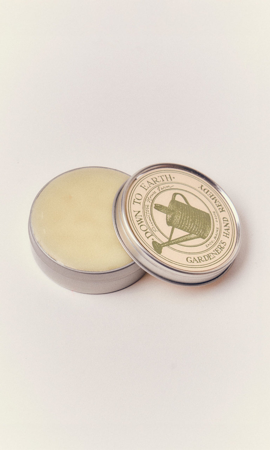 Plümo- Gardener's Hand Remedy: a round tin of nourishing hand balm, handcrafted in Maine with a gardening-themed label.