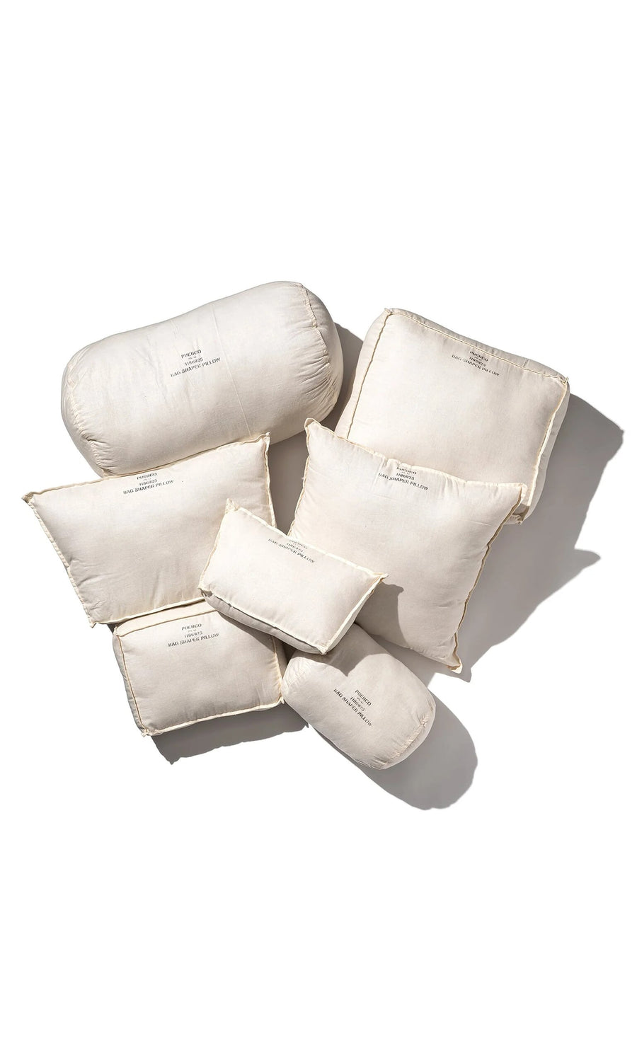 Plümo- Seven Handbag Shaper Pillow - Cylinder, white, various sizes, arranged on a white background with printed text.