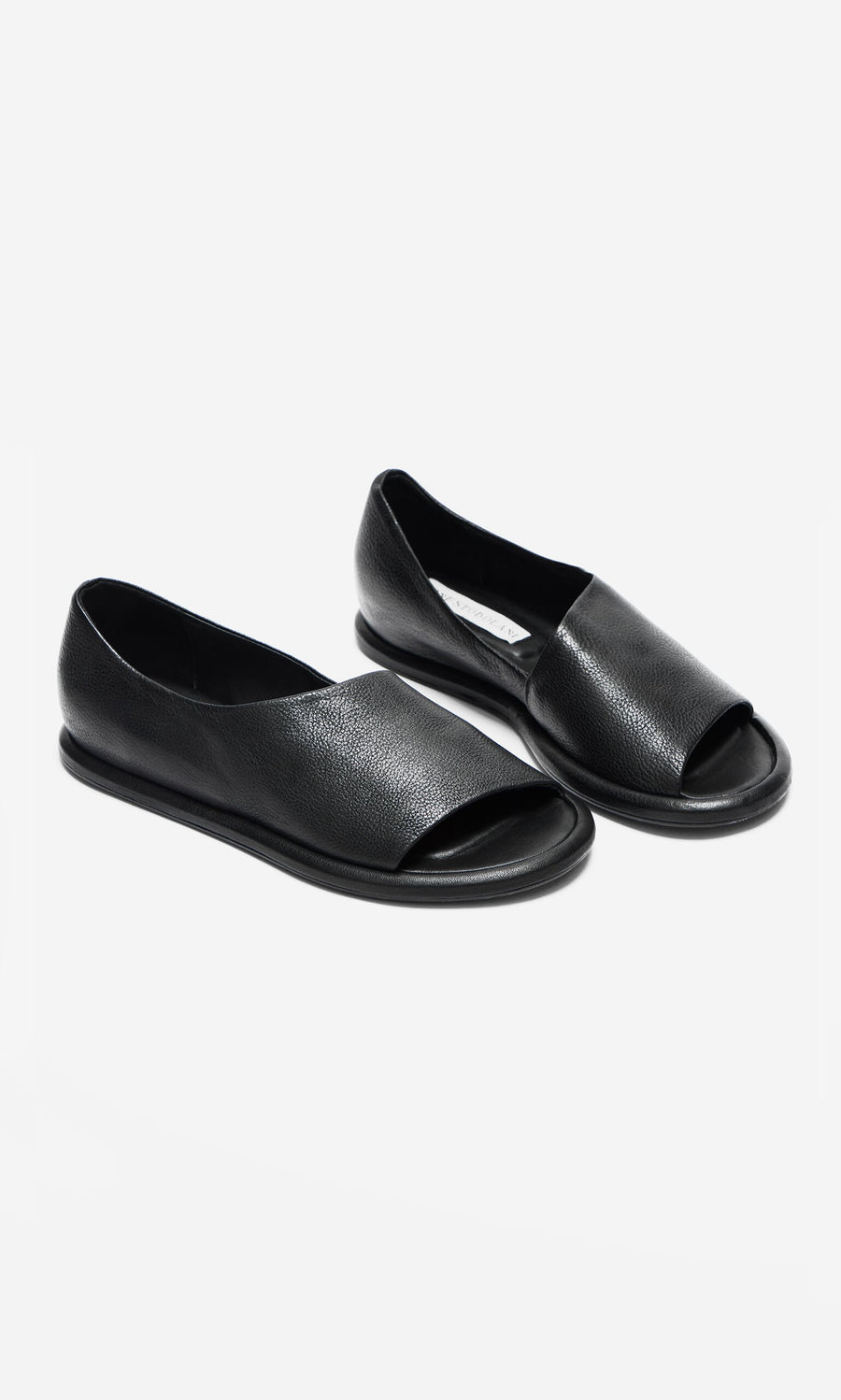 Plümo- Hawke Sandals: artisan-made black leather open-toe flats with a crisscross design on a white background.