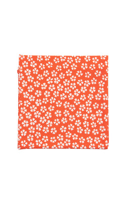Plümo  The Japanese Handkerchief - Plum features an orange background with small white plum blossoms scattered throughout.