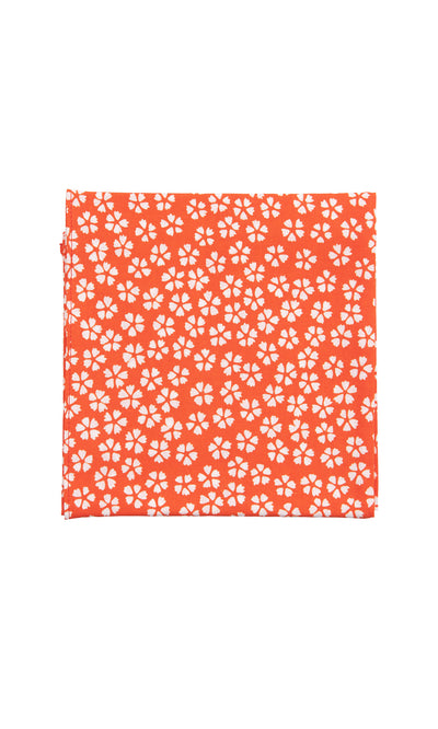 Plümo  The Japanese Handkerchief - Plum features an orange background with small white plum blossoms scattered throughout.