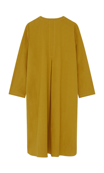 Plümo- Back view of loose-fitting, long-sleeved Kaftan Dress in mustard with center pleat, made in London.