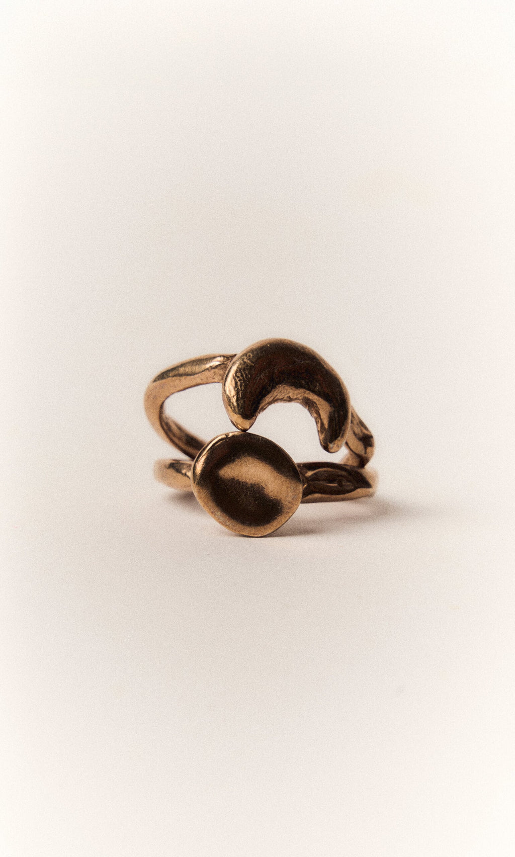 Plümo- The Moon Circle Stacking Ring features a bronze, abstract open-ended design on a plain white background.