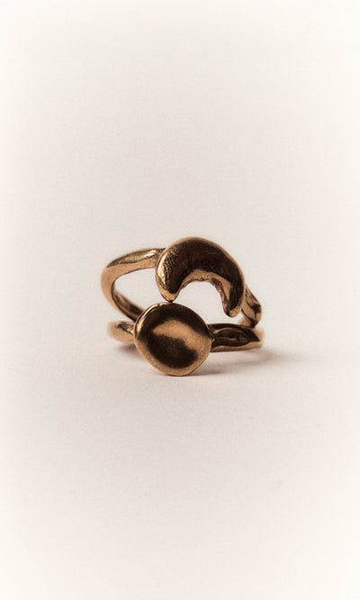 Plümo- The Moon Circle Stacking Ring features a bronze, abstract open-ended design on a plain white background.