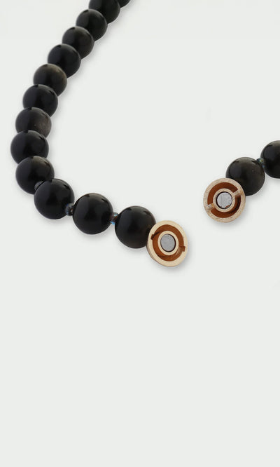 Plümo- Close-up of the Olena Necklace, featuring golden obsidian and an 18kt gold-plated clasp, on a white background.