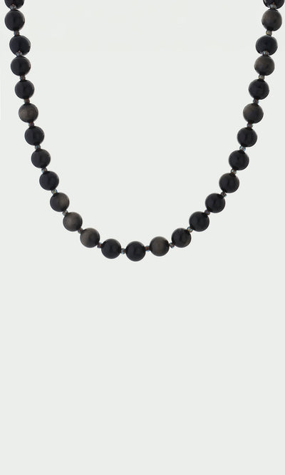 Plümo- The Olena Necklace features round, glossy black golden obsidian beads in a single strand on a white background.