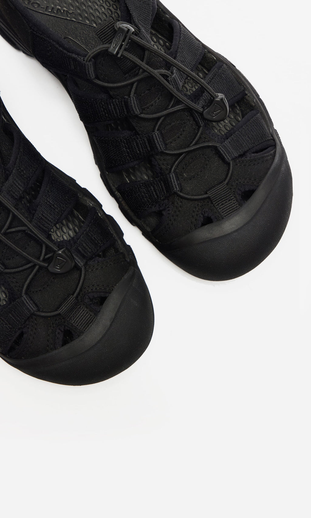 Plümo- Close-up of black Newport Sandals featuring mesh, rubber details, and arch support on a white background.