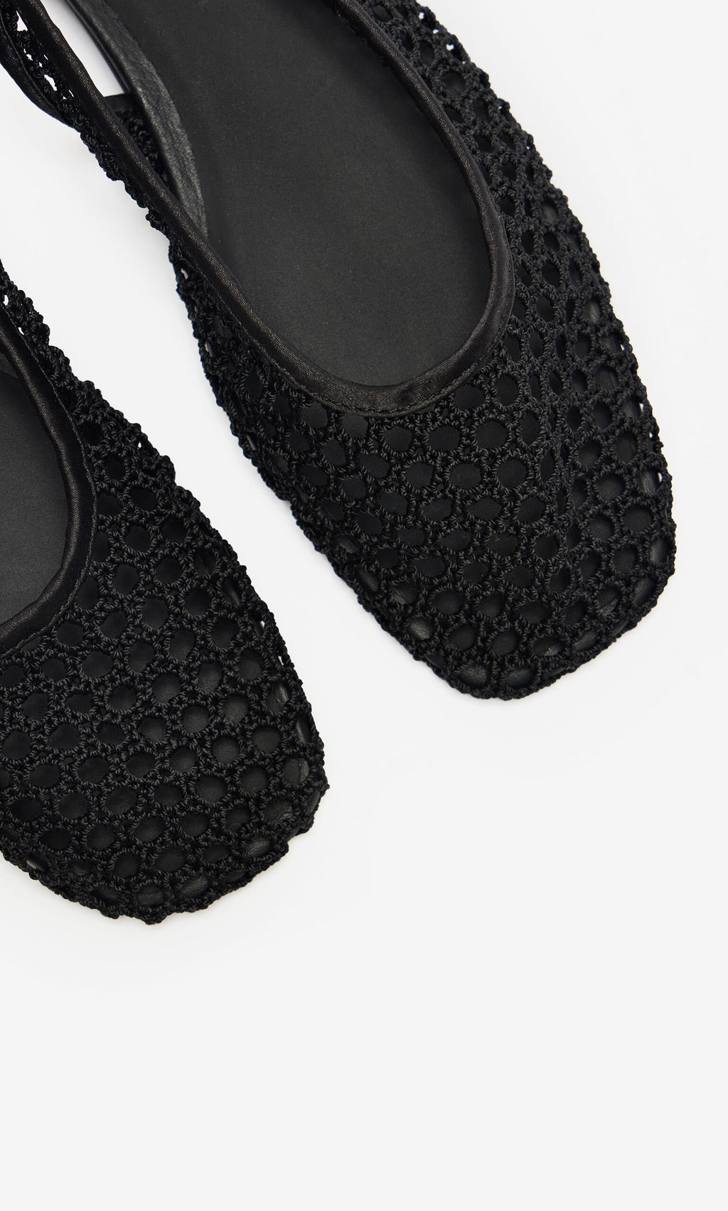 Plümo- Close-up of two black Noa Slingbacks with square toes and mesh design, displayed on a white background.