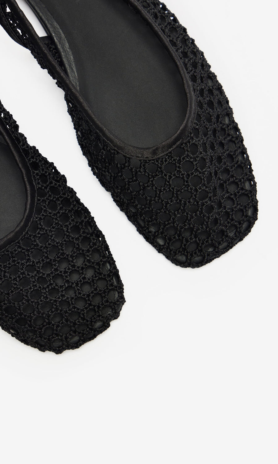 Plümo- Close-up of two black Noa Slingbacks with square toes and mesh design, displayed on a white background.
