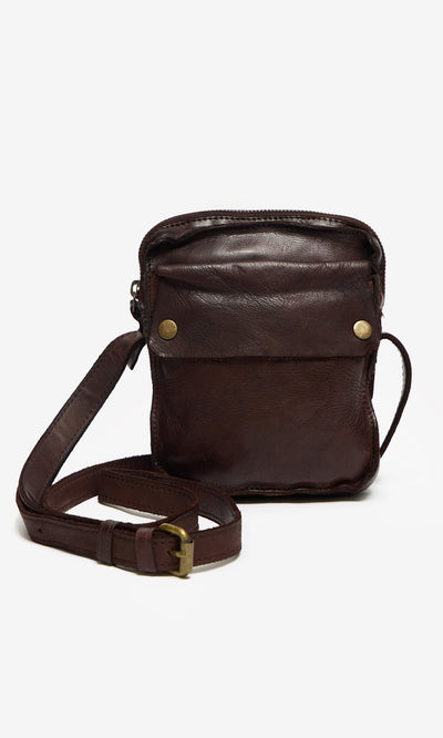 Plümo- Orton Parcel Bag: small brown leather pouch with front pocket, gold buttons, and adjustable strap—classic British style.