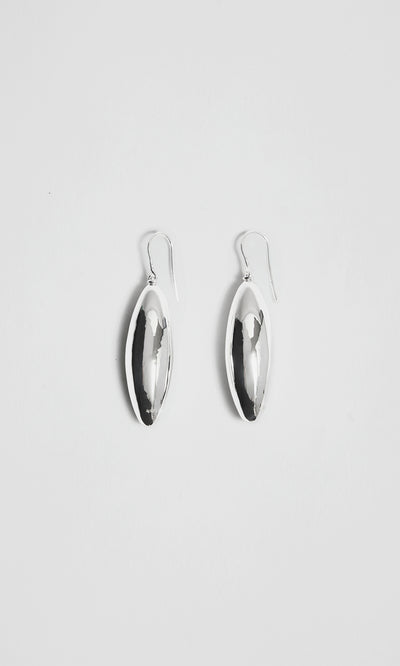 Plümo  Bea Drop Earrings: sculptural silver ovals with hooks, displayed on a plain white background.