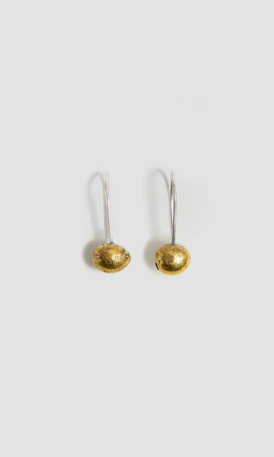 Plümo  Two Greta Earrings - Brass: silver hoops with gold oval beads, handcrafted in Cornwall on a light gray background.