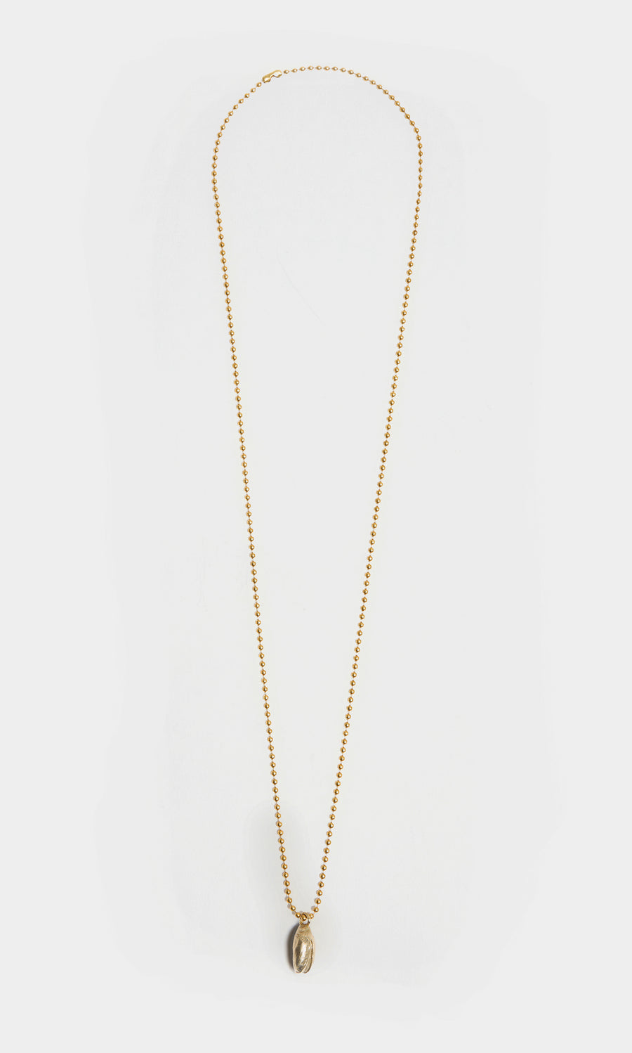 Plümo  Pistachio Pendant: Gold brass ball chain necklace with small oval pistachio pendant on white background.