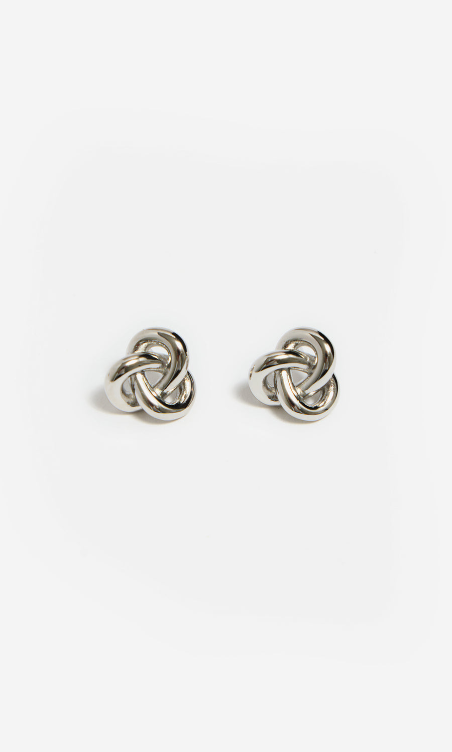 Plümo  Infinity Earrings: Silver knot-shaped studs on white background, ideal for a sculptural jewelry look.