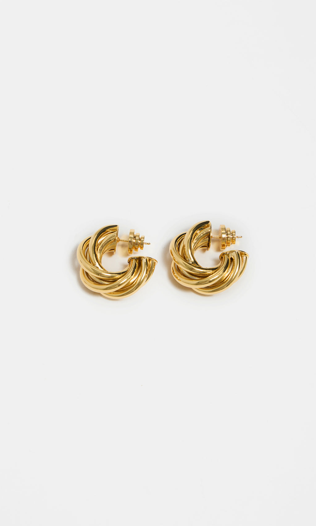 Plümo  Banda Earrings—gold-plated chunky twisted hoops with a bold intertwined design shown on a white background.
