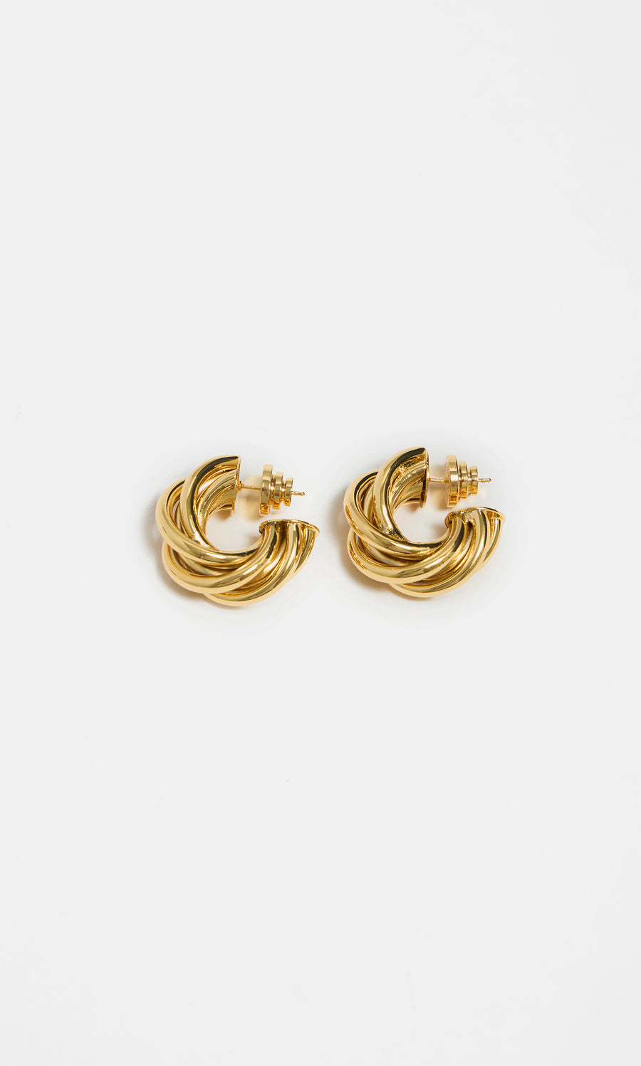 Plümo  Banda Earrings—gold-plated chunky twisted hoops with a bold intertwined design shown on a white background.