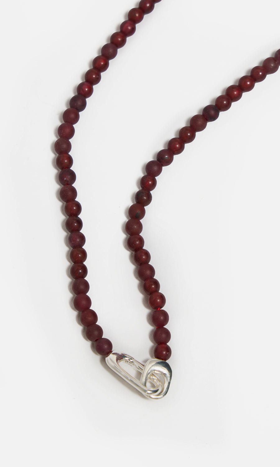 Plümo  Rowena Necklace: red jasper beads, sterling silver safety pin clasp, shown on a white background.