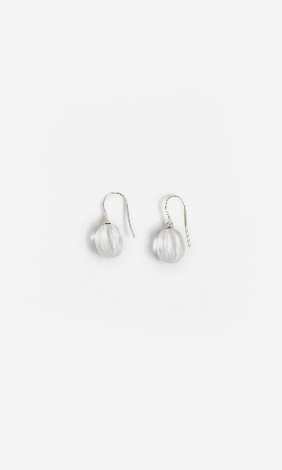Plümo  Tamsin Earrings: Handcrafted crystal quartz with clear glass beads and silver hooks on a white background.