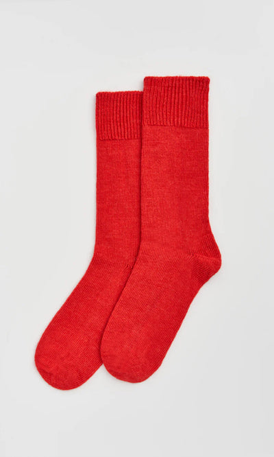 Plümo  A pair of Alpaca Socks - Postbox Red laid flat on a light gray background.