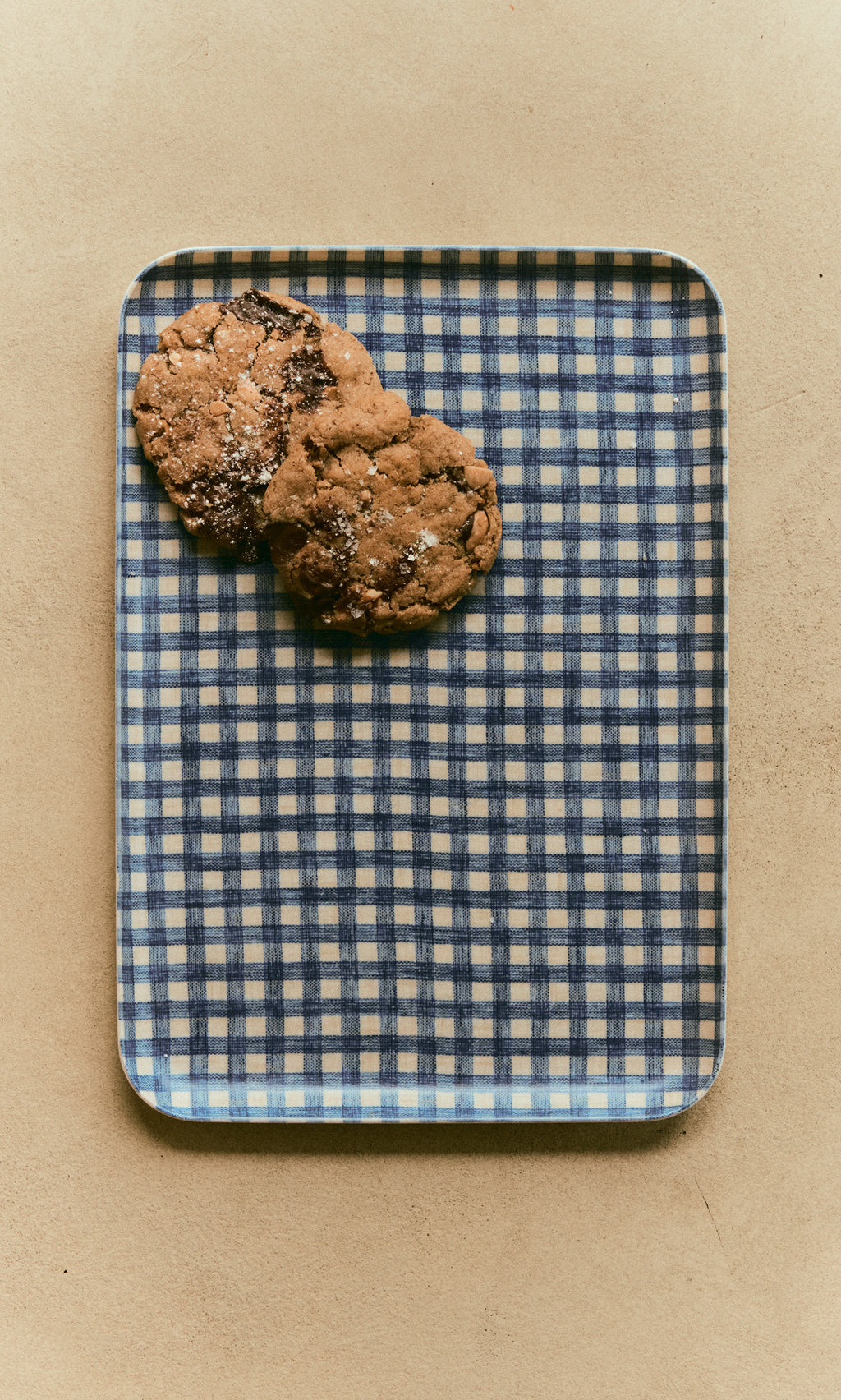 Plümo  Two chocolate chip cookies on a navy Gingham Tray - Medium.