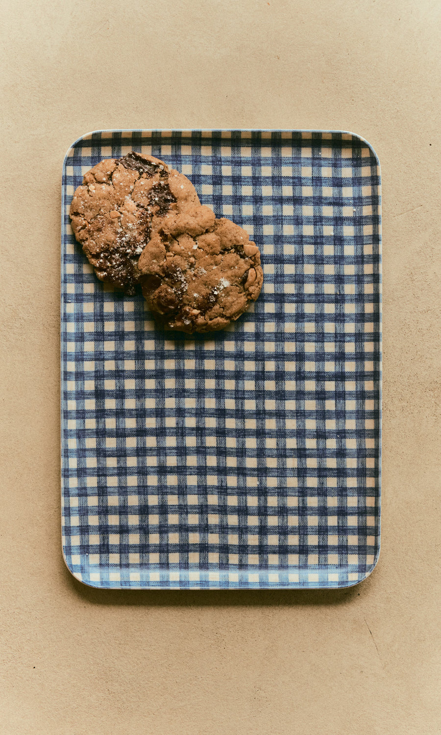 Plümo  Two chocolate chip cookies on a navy Gingham Tray - Medium.