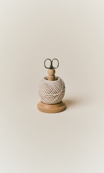 Plümo  Oak String Tidy: cotton twine holder and stainless scissors on an oak stand with a round wooden base.