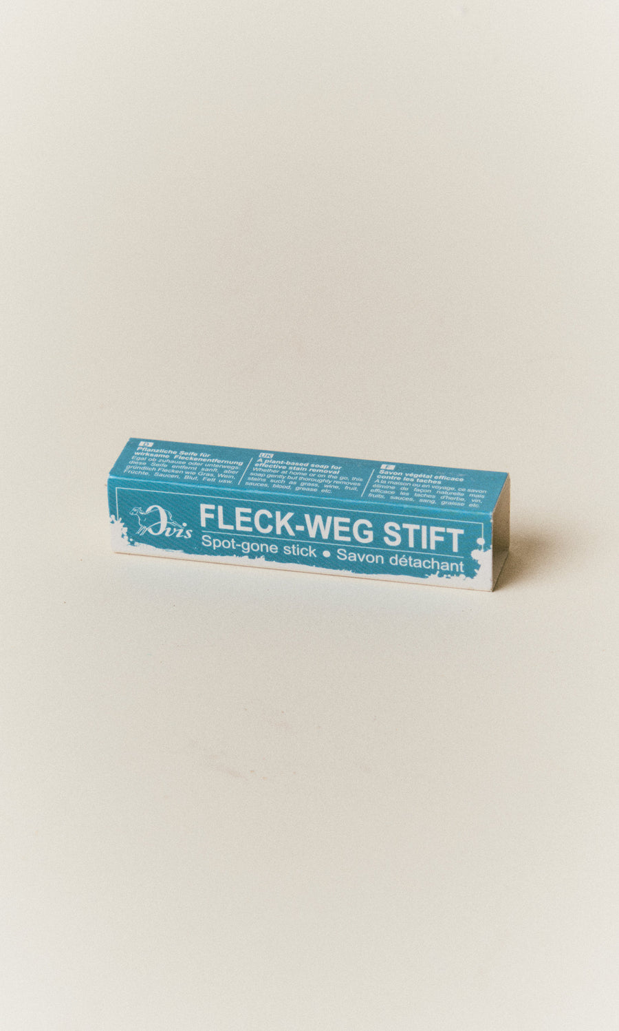 Plümo  Rectangular Stain Remover Stick box with multilingual product information on a light surface.