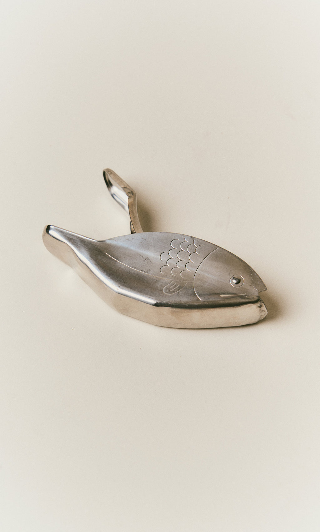 Plümo  A metal Fish Lemon Squeezer shaped like a fish.