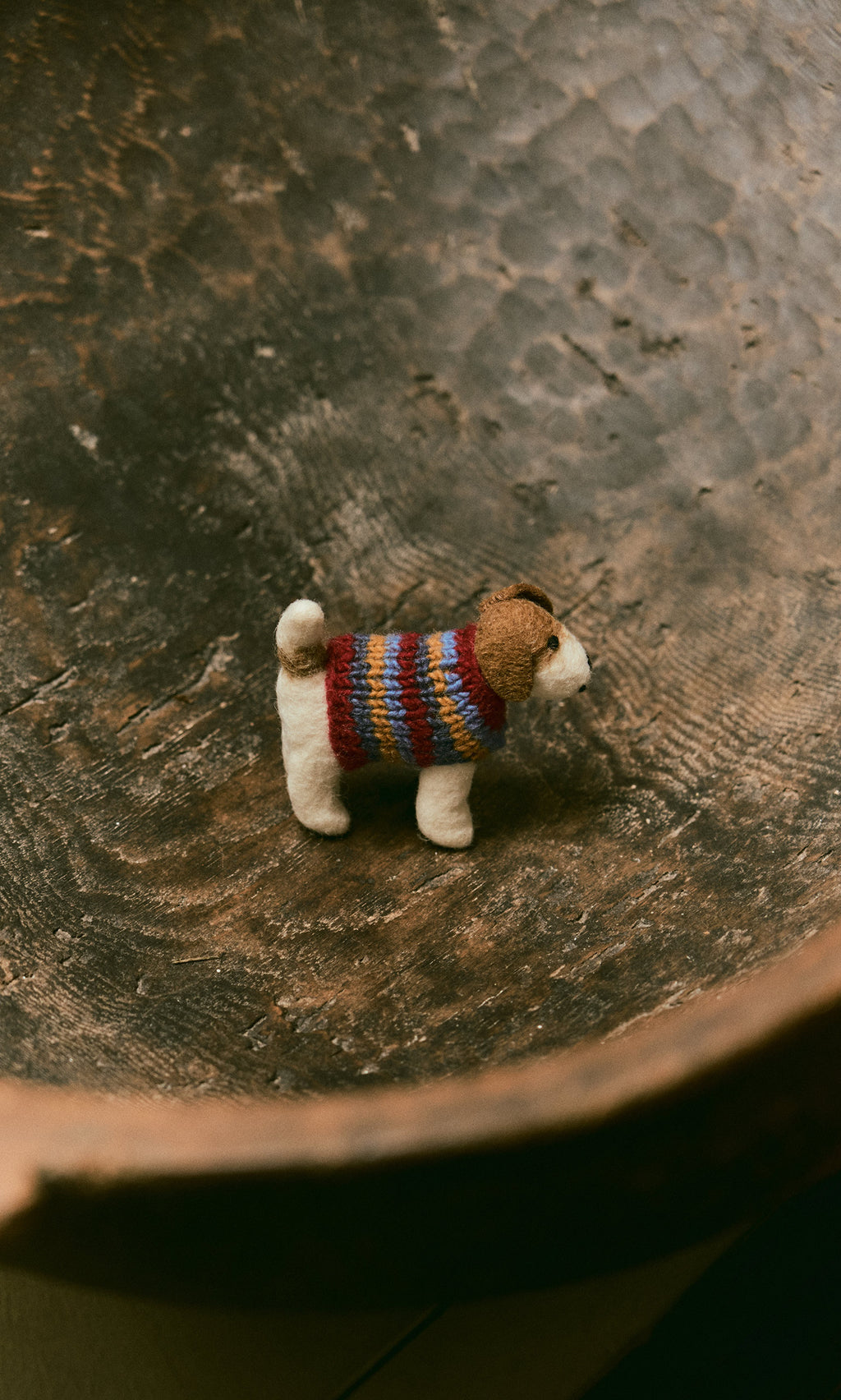 Plümo  Jack in a Jumper: A hand-felted wool figure in a colorful sweater on a rustic wooden surface.